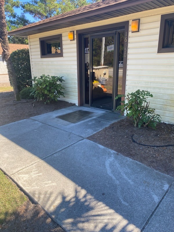 Before: Mucky, streaky concrete walkway